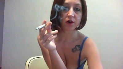 Brunette smokes cigarette sexy tits
