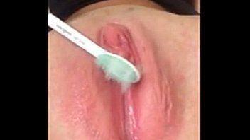 Girl using toothbrush to masturbate
